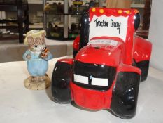 A Royal Albert tom kitten with butterfly and a red tractor pottery money box.