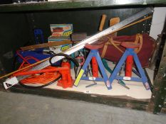 A shelf of tools including car axle stands etc.