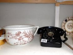 A vintage black & white telephone & a 19th century potty