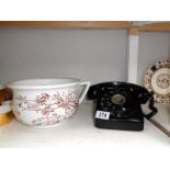 A vintage black & white telephone & a 19th century potty