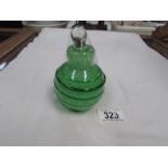 A pear shaped green glass scent bottle.