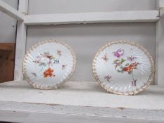 A pair of Dresden floral plates.