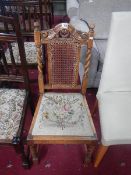 A carved wood chair with barley twist supports, cane back and tapestry seat,