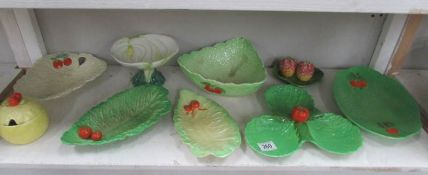 A shelf of assorted plates and dishes including Carlton Ware, Crown Devon etc.