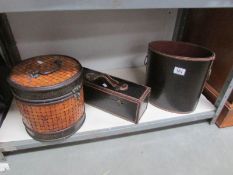 A waste paper bin, a wicker style box and a small case.