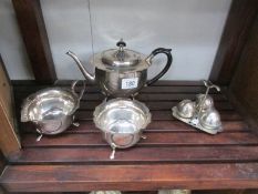 A 3 piece silver plate tea set and a cruet set.