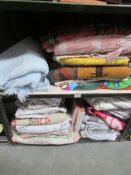 2 shelves of blankets, table cloths, duvet covers, pillow cases etc.