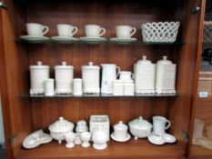 3 shelves of white table ware including storage jars, tea ware etc.