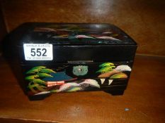 A small lacquered musical jewellery box.