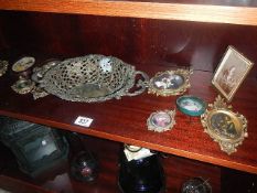 A collection of mainly metal framed miniatures and a pierced brass dish.