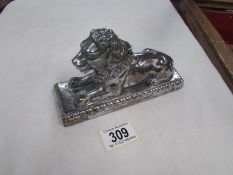 A white metal lion inkwell.