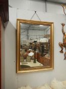 A large gilt framed mirror.