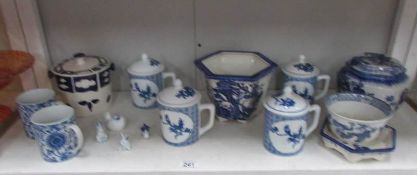 A shelf of assorted blue and white china including oriental.