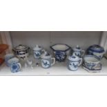A shelf of assorted blue and white china including oriental.