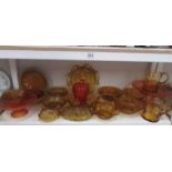 A shelf of amber and carnival glass.