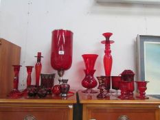 A mixed lot of red glass ware including vases, candlesticks etc.