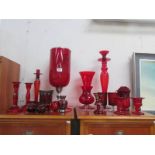 A mixed lot of red glass ware including vases, candlesticks etc.