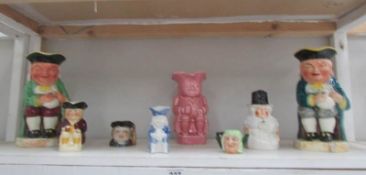 A shelf of assorted Toby jugs.