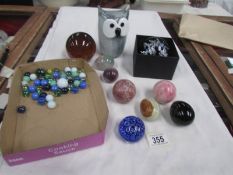A mixed lot of glass paperweights, eggs, marbles etc.