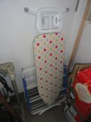 An ironing board & metal clothes horse