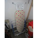 An ironing board & metal clothes horse