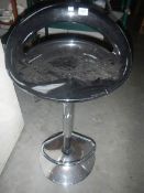 A chrome bar stool.