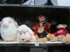 A shelf of soft toys including teddy bears, Disney's Tigger, 2 sheep etc (one is Mama's and Papa's).