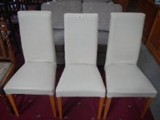 3 modern leather effect dining chairs.