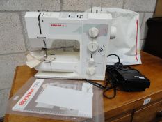 A Bernina sewing machine with foot pedal and instruction books.