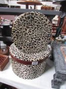 2 leopard skin effect hat boxes.