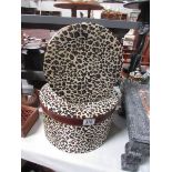 2 leopard skin effect hat boxes.