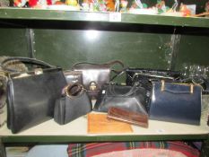 A shelf of vintage hand bags including patent leather.