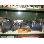 A shelf of vintage hand bags including patent leather.