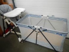 A modern child's cot and high chair.