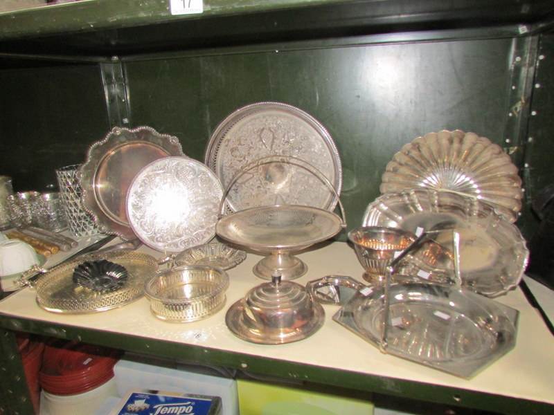 A shelf of silver plate trays etc.