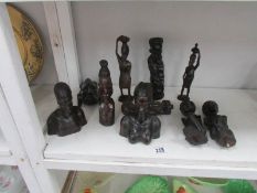 A collection of carved African figure and busts.