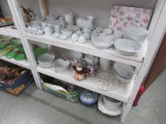 3 shelves of assorted kitchen and table ware.