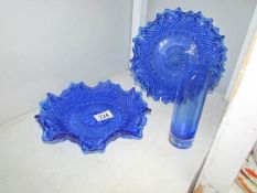 2 blue glass dishes and a blue glass vase.