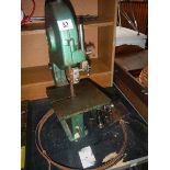 A small band saw with a chain drive for external motor (not present) and some band saws.