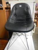 A black retro faux leather chair (a/f, marked back and missing foot).