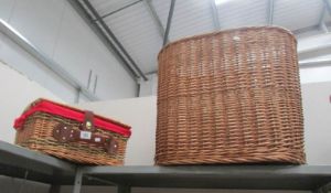 A wicker picnic basket and linen bin.