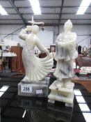 2 carved soapstone figures.