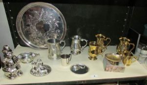 A shelf of silver plate, brass and pewter items etc.