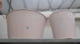A pink metal wash tub and bucket.