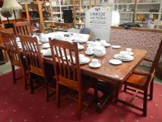 A large heavy dining table and 5 chairs.