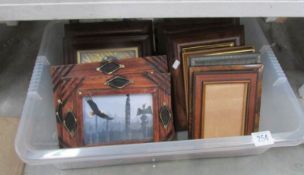 A box of assorted pictures and frames.