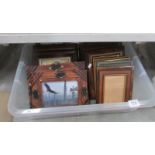 A box of assorted pictures and frames.