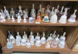 2 shelves of assorted pottery and metal bells.