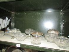 A quantity of glass and metal flower holders.