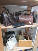 2 shelves of assorted hand bags.